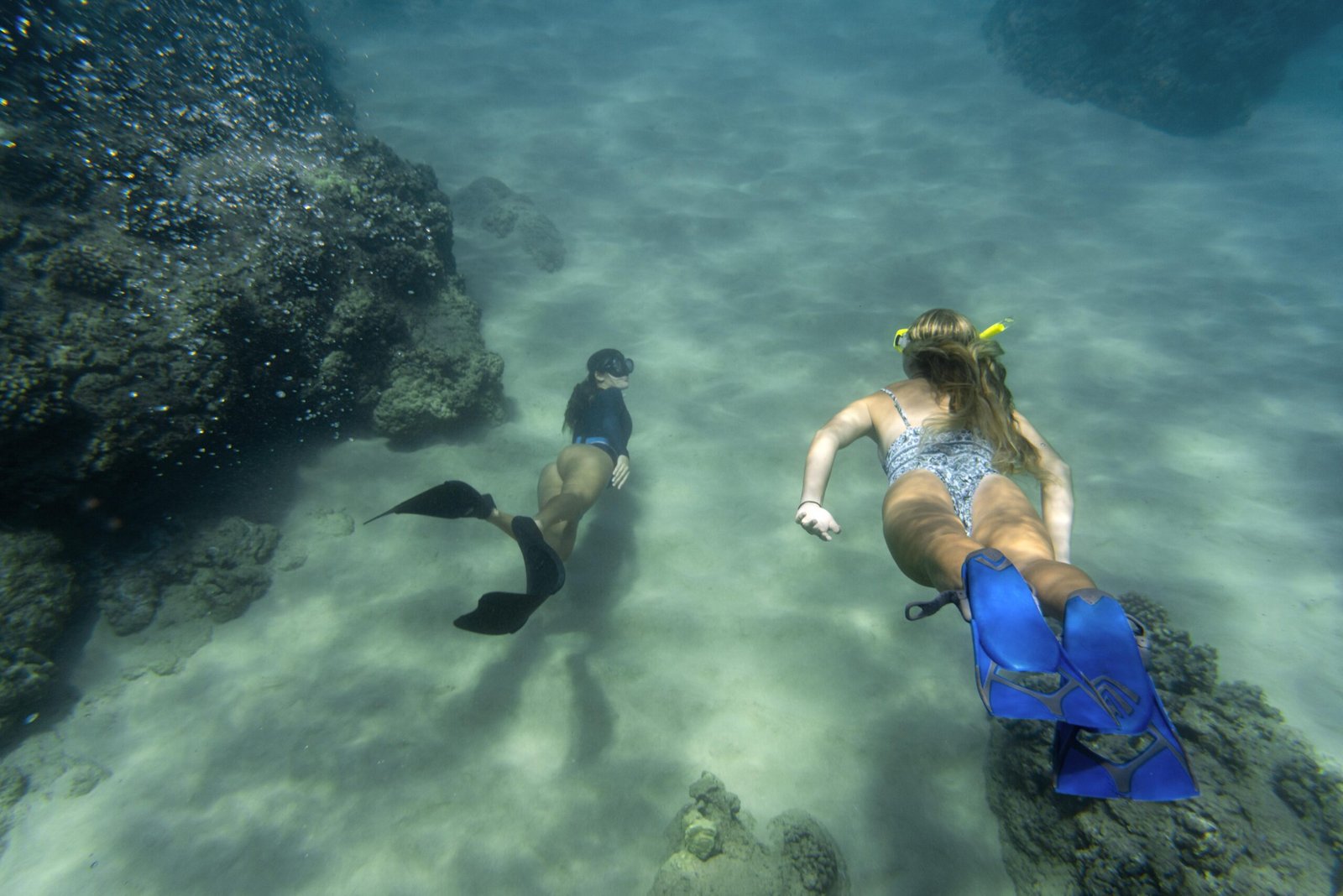 Divers exploring coral reefs in Menjangan vs Nusa Penida underwater comparison