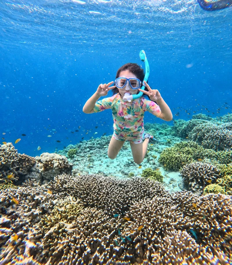 Young snorkeler underwater above the coral at Menjangan Island